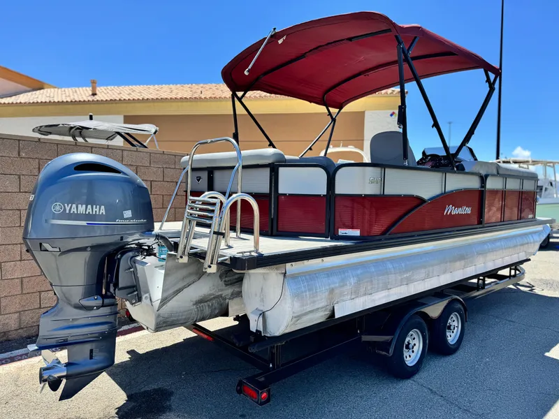 Slide: The Image of 2019 Manitou 23 Oasis pontoon boat with Yamaha engine on trailer. - 6