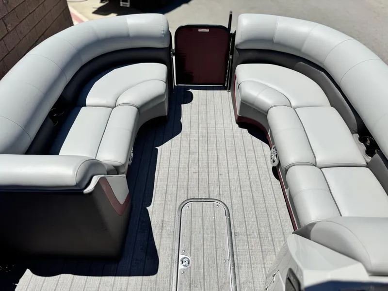 Slide: The Image of 2019 Manitou 23 Oasis boat interior with gray seating and carpeted floor. - 9