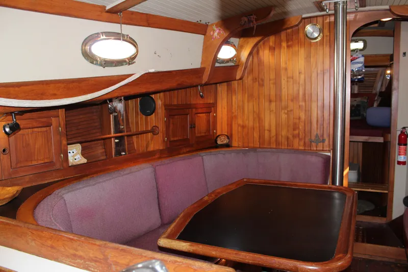 Slide: The Image of 1979 Hans Christian 38 Ketch interior with wooden paneling and cozy seating area. - 11