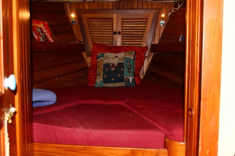 Slide: The Image of Cozy cabin interior of 1979 Hans Christian 38 Ketch with red bedding and decorative pillows. - 14