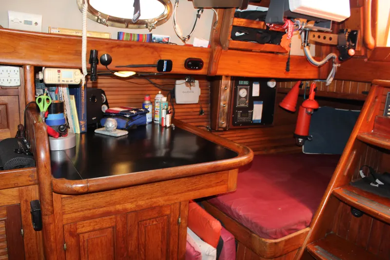 Slide: The Image of Interior of 1979 Hans Christian 38 Ketch with wooden cabinetry and navigation station. - 15