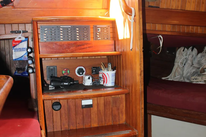 Slide: The Image of Interior of 1979 Hans Christian 38 Ketch with wooden paneling and navigation equipment. - 18
