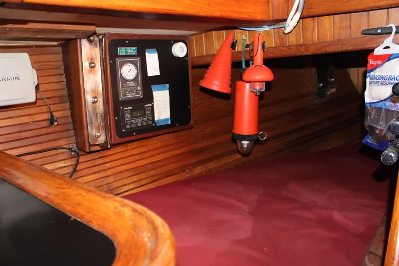 Slide: The Image of 1979 Hans Christian 38 Ketch interior with wooden paneling and navigation equipment. - 20
