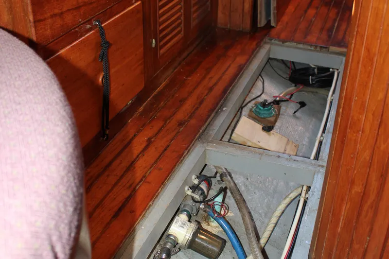 Slide: The Image of Interior view of 1979 Hans Christian 38 Ketch showing open floor panel with visible wiring and components. - 32