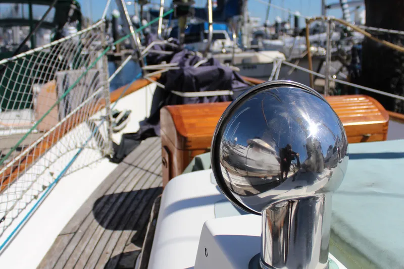 Slide: The Image of 1979 Hans Christian 38 Ketch deck with polished metal detail and nautical equipment. - 4