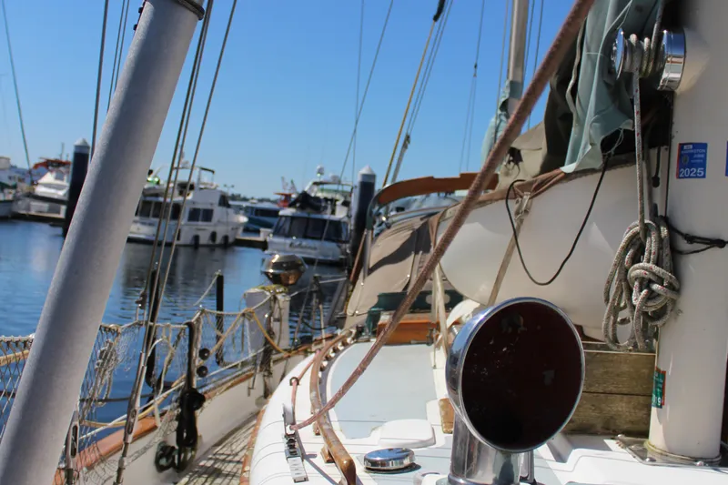 Slide: The Image of 1979 Hans Christian 38 Ketch sailboat docked at a marina, surrounded by other boats. - 5