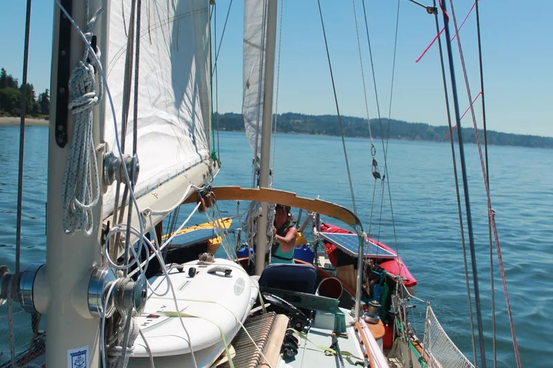 Slide: The Image of 1979 Hans Christian 38 Ketch sailing on calm waters under clear skies. - 8