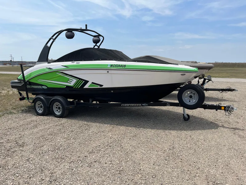 Slide: The Image of 2016 Chaparral Vortex 223 VRX boat on trailer, featuring green and black accents. - 0