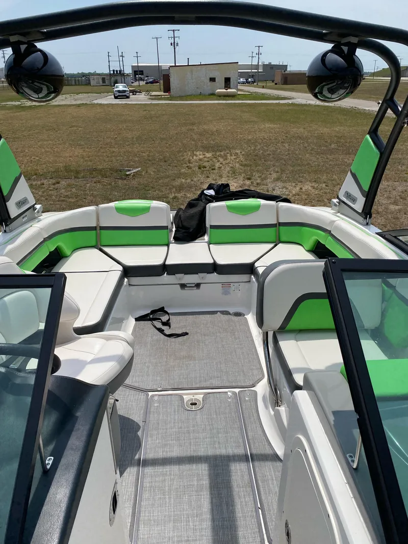 Slide: The Image of 2016 Chaparral Vortex 223 VRX boat interior with green and white seating. - 11