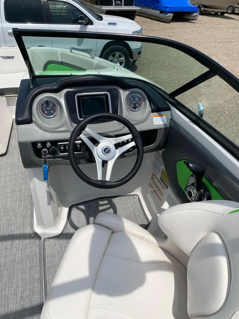 Slide: The Image of 2016 Chaparral Vortex 223 VRX boat cockpit with steering wheel and dashboard controls. - 4