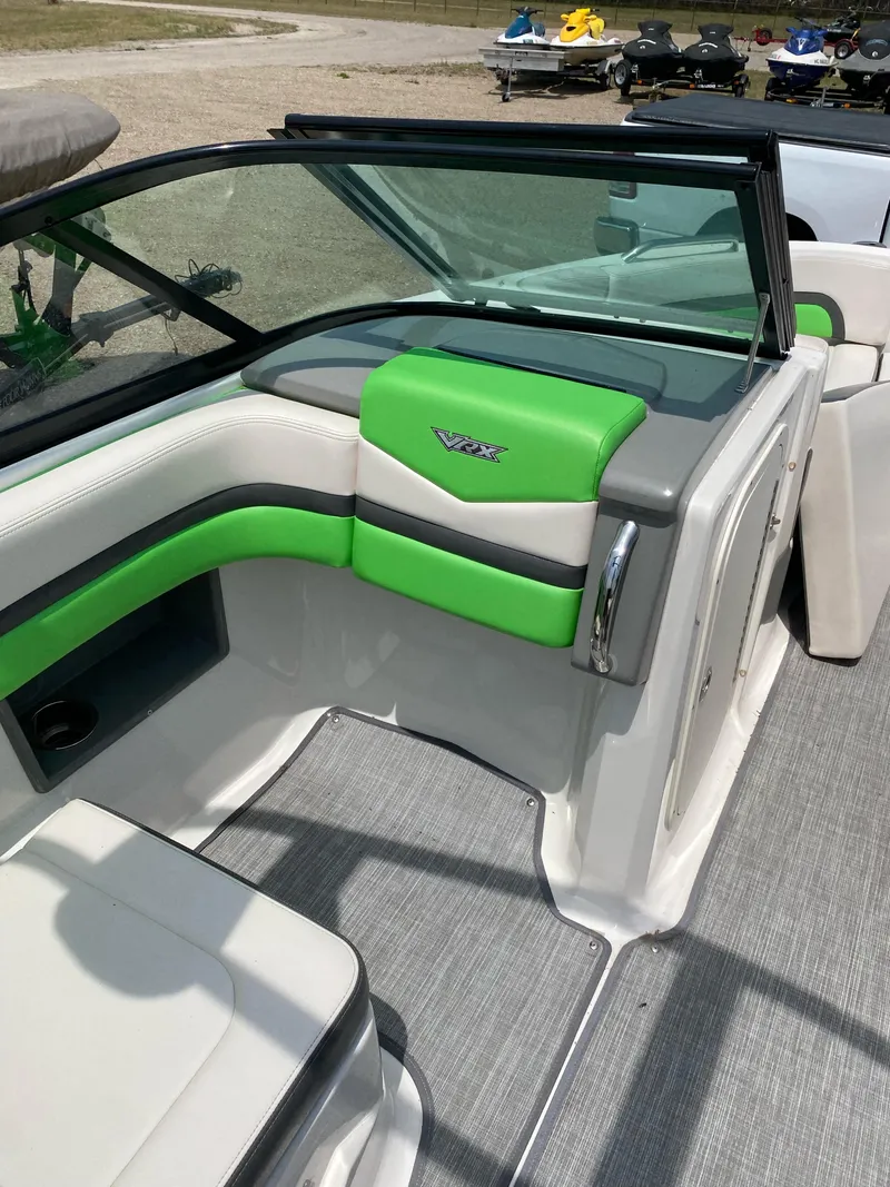 Slide: The Image of 2016 Chaparral Vortex 223 VRX boat interior with green and gray seating. - 7