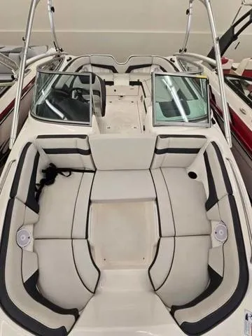 Slide: The Image of 2015 Yamaha AR210 boat interior with spacious seating and sleek design. - 16