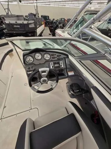 Slide: The Image of 2015 Yamaha AR210 boat dashboard with steering wheel and control panel. - 8