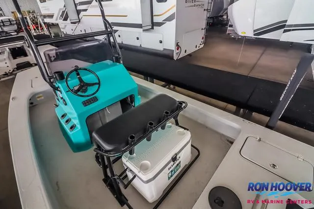 Slide: The Image of 2025 Majek 18 M2 boat interior with teal console and seating at Ron Hoover RV & Marine Centers. - 10