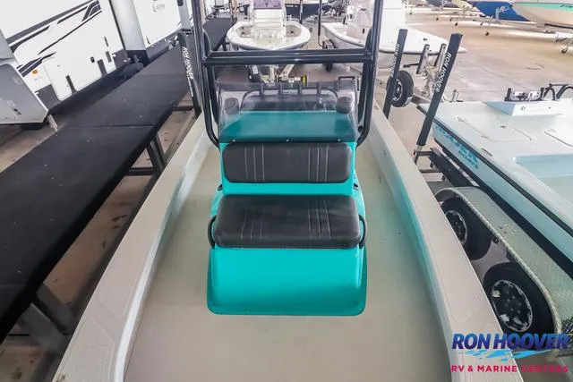 Slide: The Image of 2025 Majek 18 M2 boat with teal seating, displayed at Ron Hoover RV & Marine. - 13