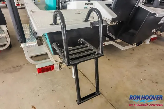 Slide: The Image of 2025 Majek 18 M2 boat with a foldable boarding ladder in a showroom. - 23