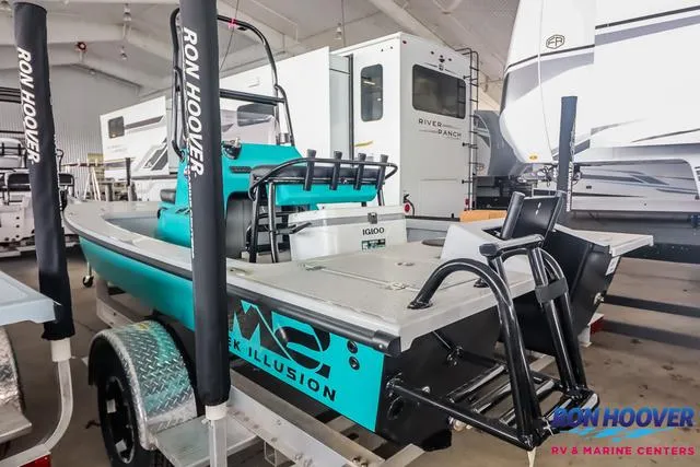 Slide: The Image of 2025 Majek 18 M2 boat in showroom, turquoise color, displayed at Ron Hoover RV & Marine Centers. - 4