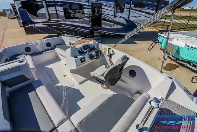 Slide: The Image of 2025 Starcraft SVX171 boat interior with seating and steering console, displayed outdoors. - 11