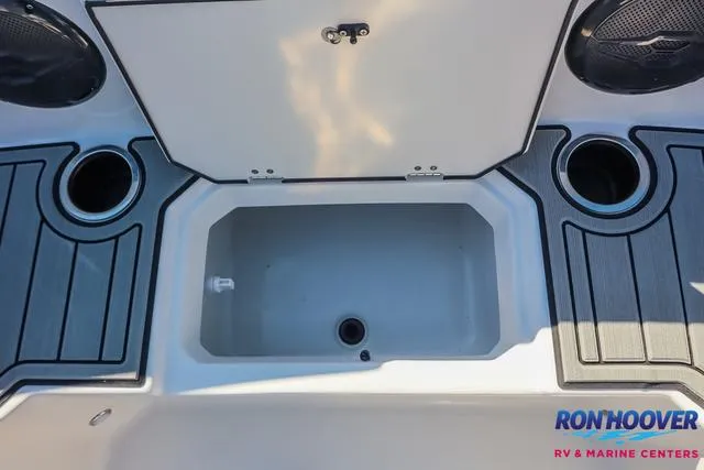 Slide: The Image of 2025 Starcraft SVX171 boat deck with storage compartment and cup holders. - 14