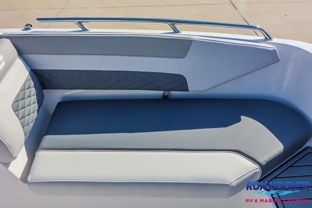 Slide: The Image of 2025 Starcraft SVX171 boat interior with gray cushioned seating and sleek design. - 16
