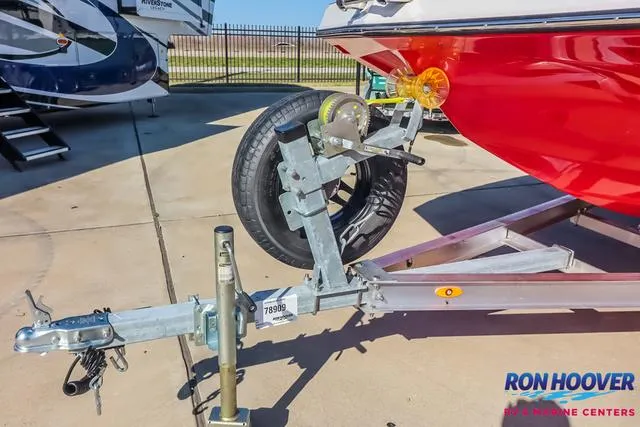 Slide: The Image of 2025 Starcraft SVX171 boat on trailer, featuring red hull and spare tire, at Ron Hoover RV & Marine. - 30