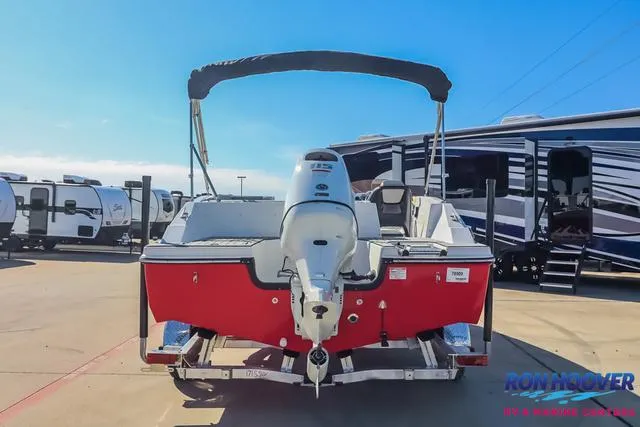 Slide: The Image of 2025 Starcraft SVX171 boat with outboard motor, parked near RVs under clear sky. - 5