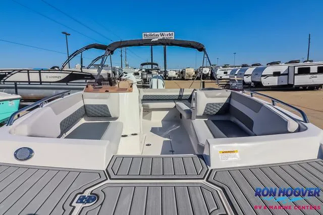 Slide: The Image of 2025 Starcraft SVX171 boat with spacious seating, displayed at a marine center. - 6