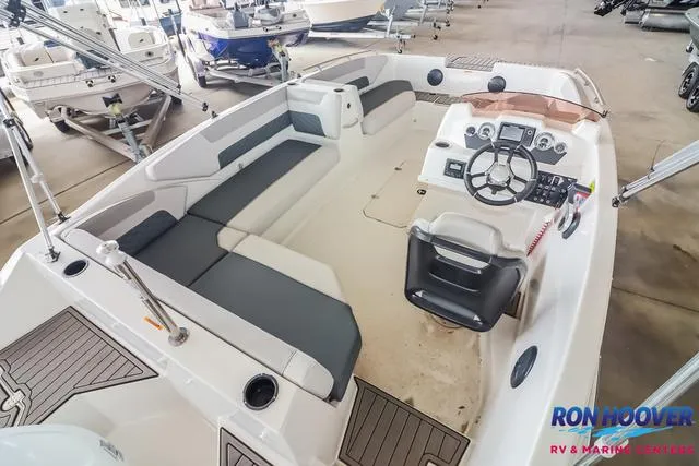 Slide: The Image of 2025 Starcraft SVX171 boat interior with seating and control panel in showroom. - 11