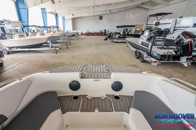 Slide: The Image of 2025 Starcraft SVX171 boat interior in showroom with various boats displayed. - 13