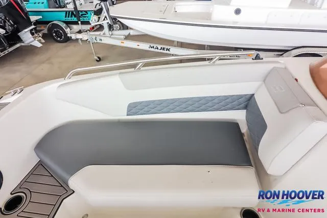 Slide: The Image of 2025 Starcraft SVX171 boat interior with gray seating at Ron Hoover RV & Marine Centers. - 15