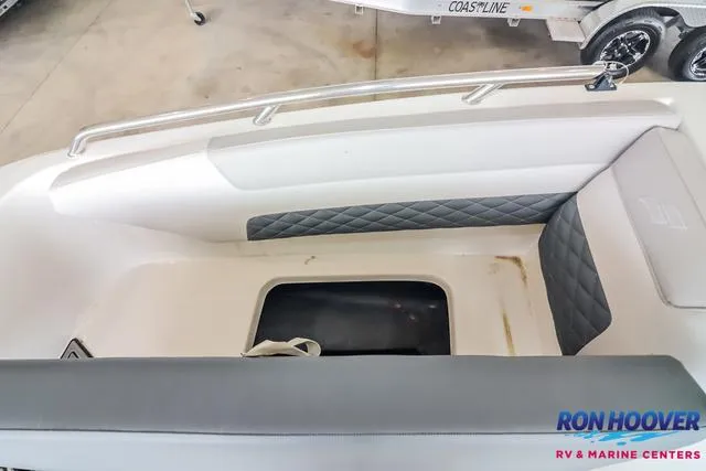Slide: The Image of 2025 Starcraft SVX171 boat interior with storage compartment, quilted seating, and Ron Hoover branding. - 16
