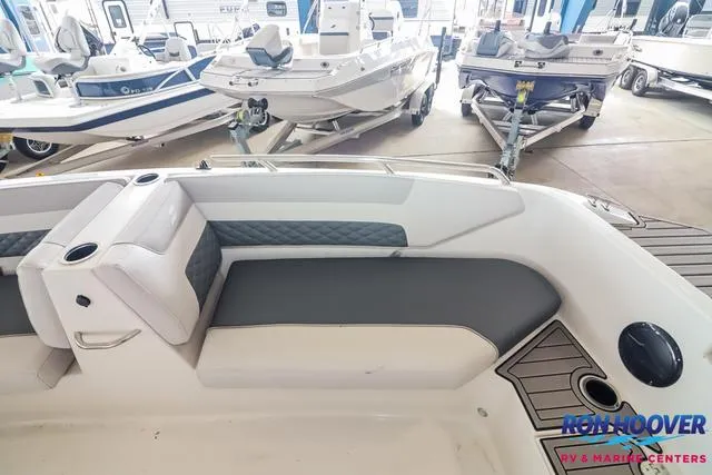 Slide: The Image of 2025 Starcraft SVX171 boat interior with gray seating and cup holder, displayed at Ron Hoover RV & Marine Centers. - 17