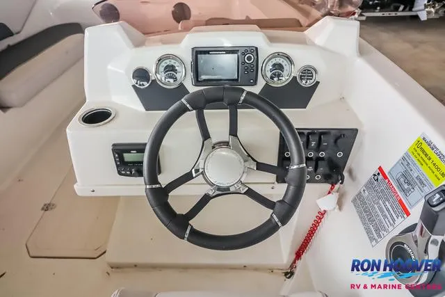 Slide: The Image of 2025 Starcraft SVX171 boat dashboard with steering wheel, gauges, and control panel. - 22