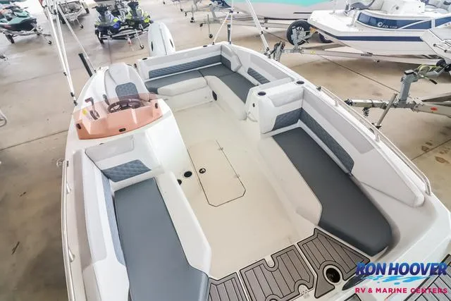 Slide: The Image of 2025 Starcraft SVX171 boat interior with spacious seating and modern design in showroom. - 9