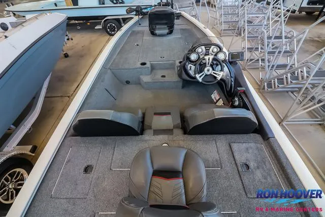 Slide: The Image of 2021 Tracker Pro Team 190 TX TE boat interior with steering console and seating. - 10