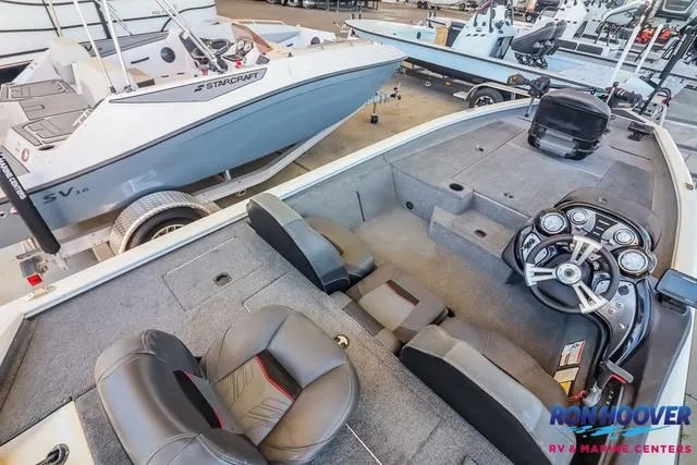 Slide: The Image of 2021 Tracker Pro Team 190 TX TE boat interior with steering console and seating. - 11