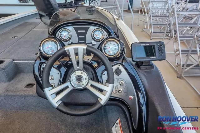 Slide: The Image of 2021 Tracker Pro Team 190 TX TE boat dashboard with steering wheel and gauges. - 20