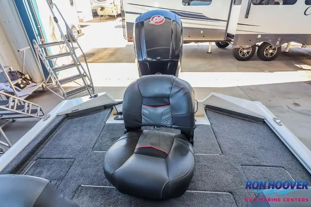 Slide: The Image of 2021 Tracker Pro Team 190 TX TE boat interior with black seating and motor. - 22