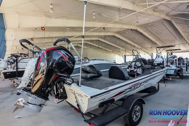 Slide: The Image of 2021 Tracker Pro Team 190 TX TE boat in showroom, featuring powerful outboard motor. - 6