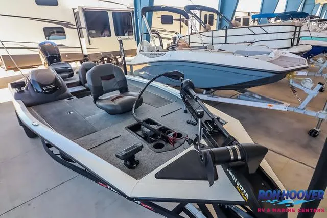 Slide: The Image of 2021 Tracker Pro Team 190 TX TE fishing boat in showroom, featuring spacious deck and seating. - 9