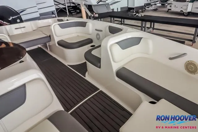 Slide: The Image of 2020 Bayliner Element E18 boat interior with gray seating and black flooring. - 10
