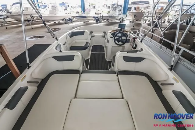 Slide: The Image of 2020 Bayliner Element E18 boat interior with seating and steering wheel in showroom. - 11
