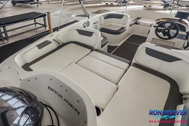 Slide: The Image of 2020 Bayliner Element E18 boat interior with white seating and steering wheel. - 12