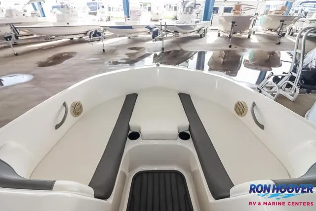 Slide: The Image of 2020 Bayliner Element E18 boat interior with cushioned seating in showroom. - 14