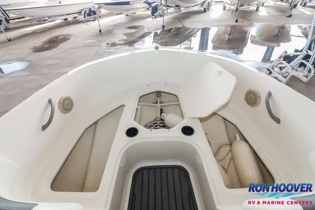Slide: The Image of 2020 Bayliner Element E18 boat interior with storage compartments and cup holders. - 15