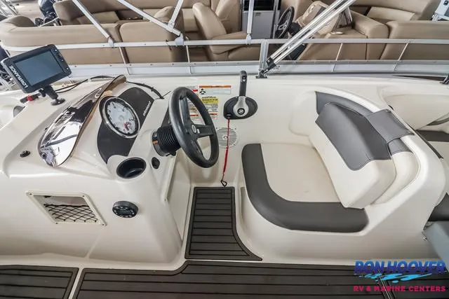 Slide: The Image of 2020 Bayliner Element E18 boat interior with steering wheel and seating area. - 18