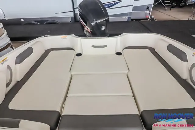 Slide: The Image of 2020 Bayliner Element E18 boat interior with cushioned seating and outboard motor. - 21