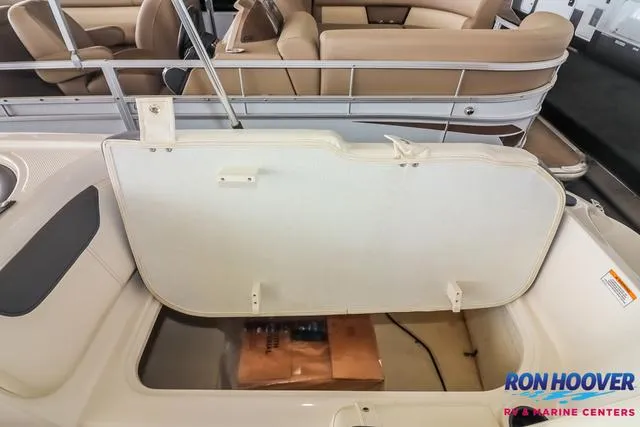 Slide: The Image of 2020 Bayliner Element E18 storage compartment open, showcasing interior space. - 22