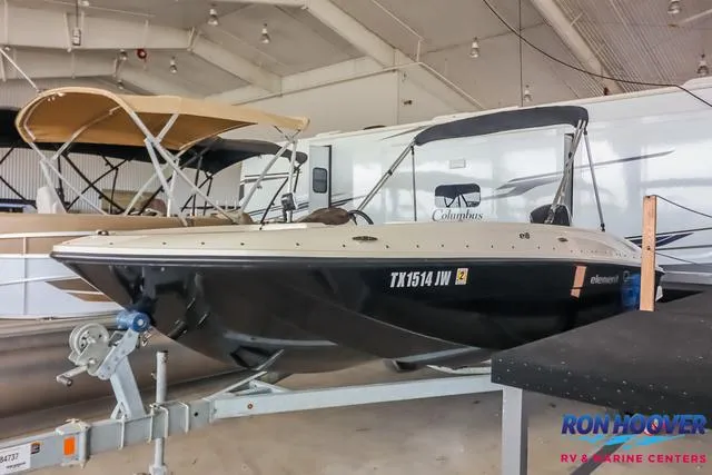 Slide: The Image of 2020 Bayliner Element E18 boat on trailer in indoor showroom. - 3