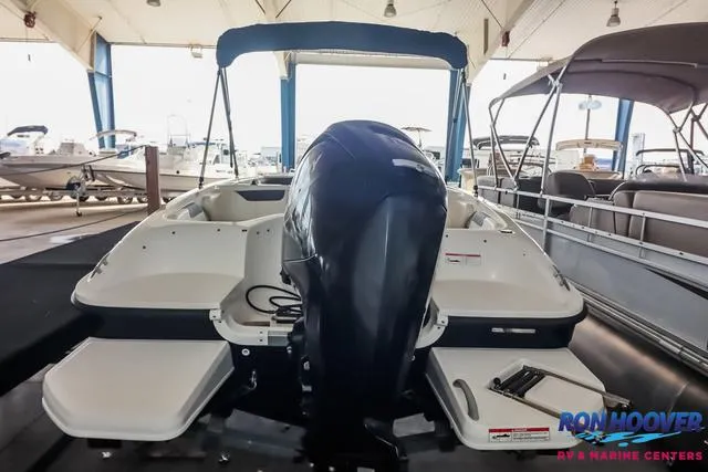 Slide: The Image of 2020 Bayliner Element E18 boat with outboard motor in a showroom. - 6